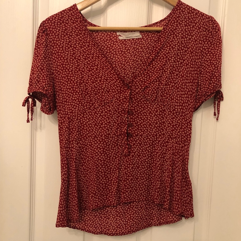 Red top with off white flowers. Size small.